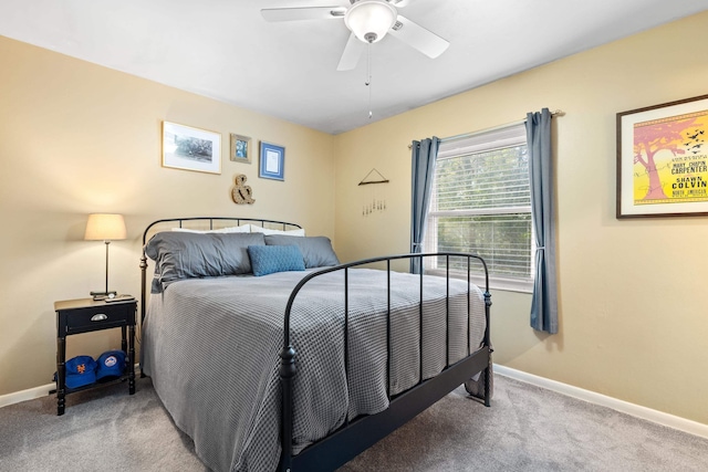 carpeted bedroom with baseboards and a ceiling fan