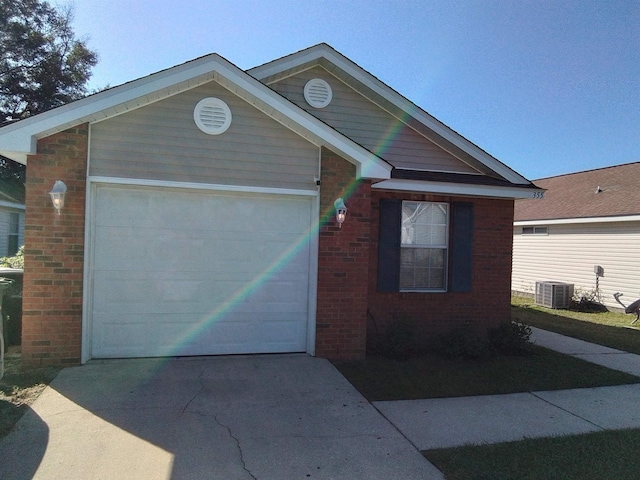 view of front facade with central AC and a garage