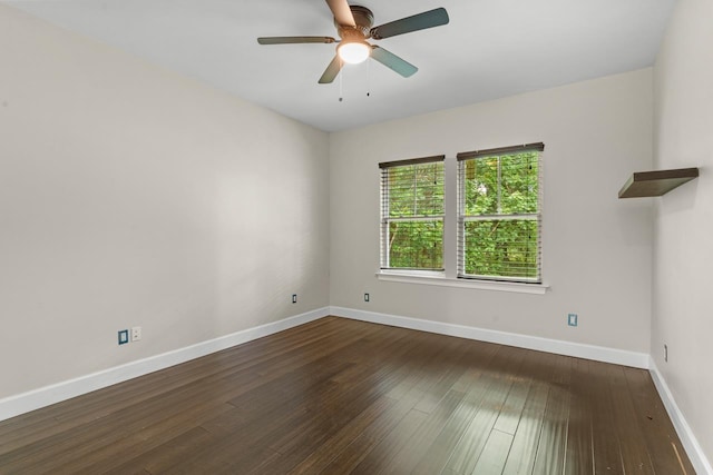 empty room featuring dark wood-type flooring and ceiling fan