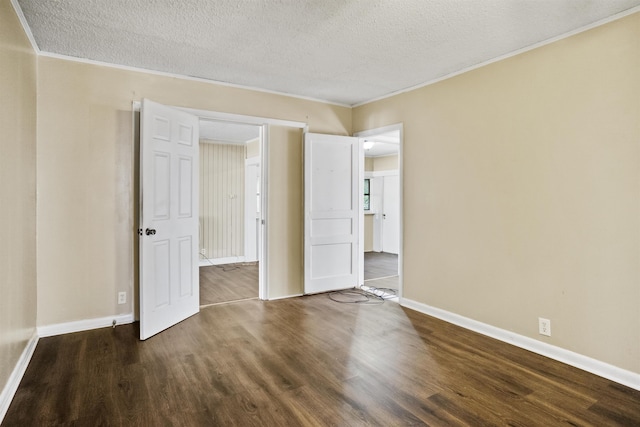 unfurnished bedroom featuring ornamental molding, dark hardwood / wood-style floors, and a textured ceiling