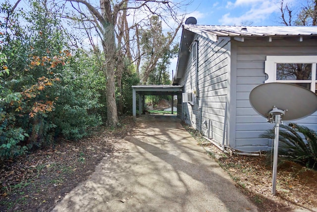 view of property exterior with cooling unit and a carport