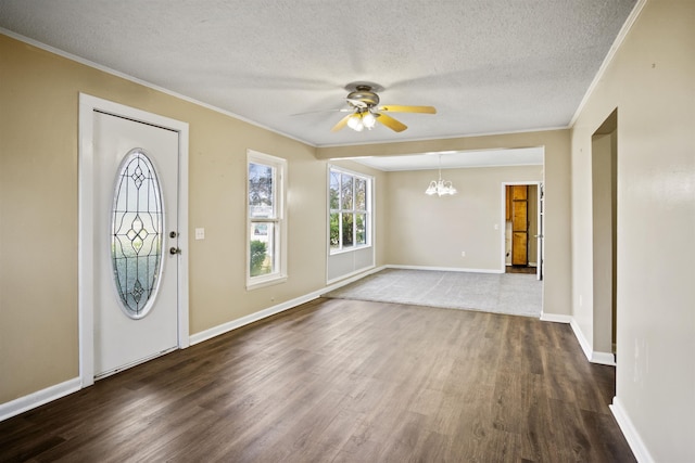 entryway with crown molding, dark hardwood / wood-style flooring, ceiling fan with notable chandelier, and a textured ceiling