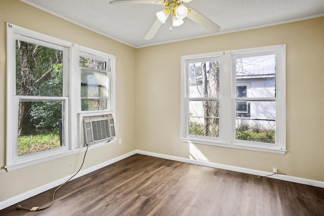 spare room with cooling unit, hardwood / wood-style flooring, ornamental molding, and ceiling fan