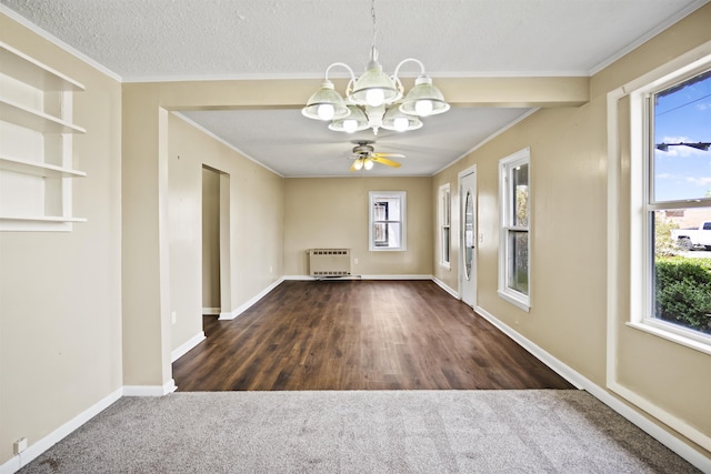 unfurnished dining area with crown molding, radiator, an inviting chandelier, and a textured ceiling