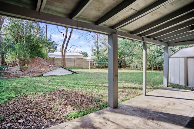 view of yard with a patio and a storage unit