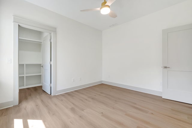 unfurnished bedroom with ceiling fan, a closet, and light hardwood / wood-style floors