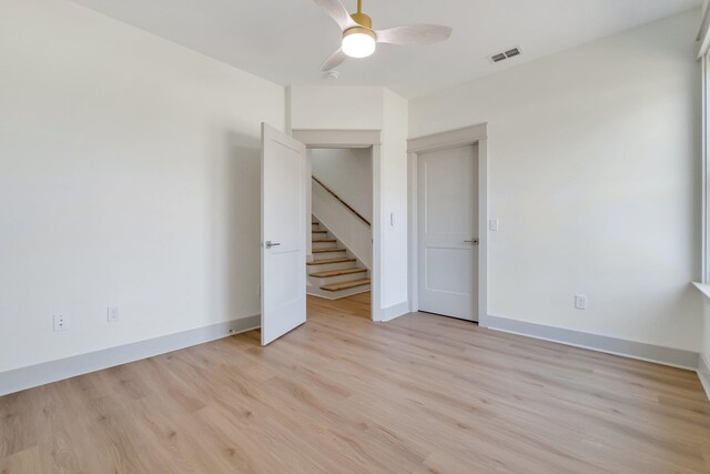 unfurnished room with ceiling fan and light hardwood / wood-style floors