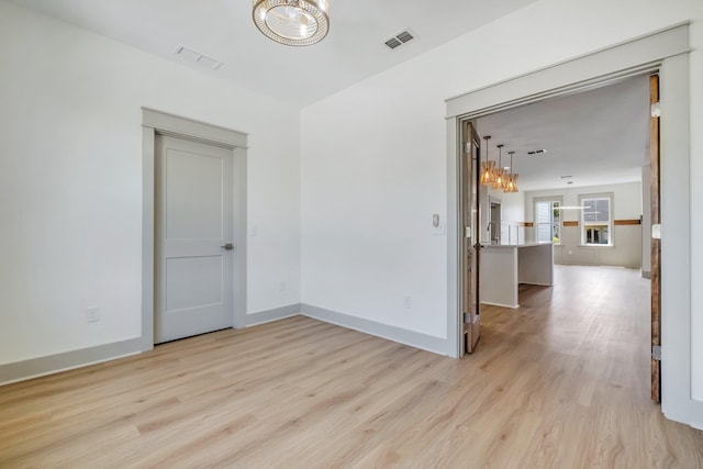 unfurnished room with light hardwood / wood-style floors