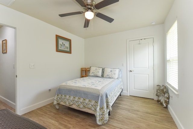 359 Mae Cato Dr, Midway, FL 32343 - bedroom with baseboards, light wood-style flooring, and multiple windows