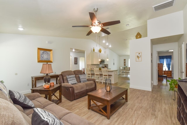 359 Mae Cato Dr, Midway, FL 32343 - living area featuring vaulted ceiling, light wood finished floors, ceiling fan, and baseboards