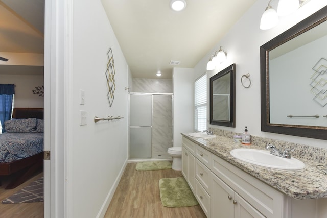 359 Mae Cato Dr, Midway, FL 32343 - full bathroom with connected bathroom, double vanity, a stall shower, wood finished floors, and toilet