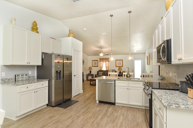 359 Mae Cato Dr, Midway, FL 32343 - kitchen with appliances with stainless steel finishes, a sink, light wood-style floors, a peninsula, and white cabinets