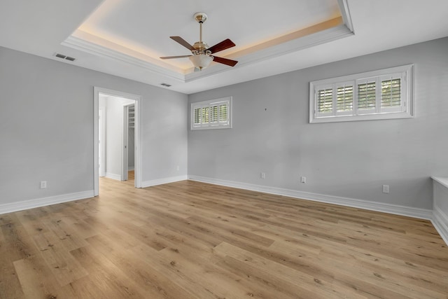4653 Soaring Way, Tallahassee, FL 32311 - empty room with a raised ceiling, light wood-style floors, ceiling fan, and baseboards
