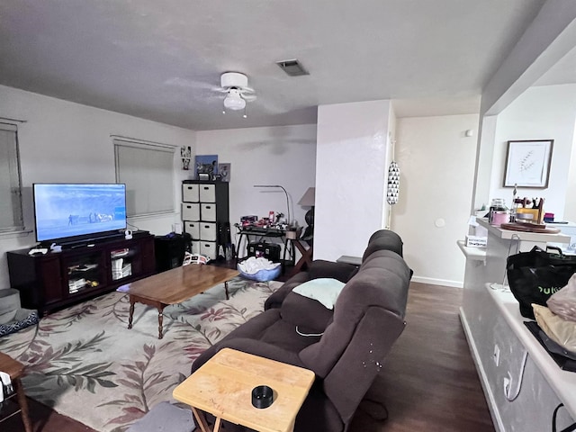 living room featuring ceiling fan and dark hardwood / wood-style flooring