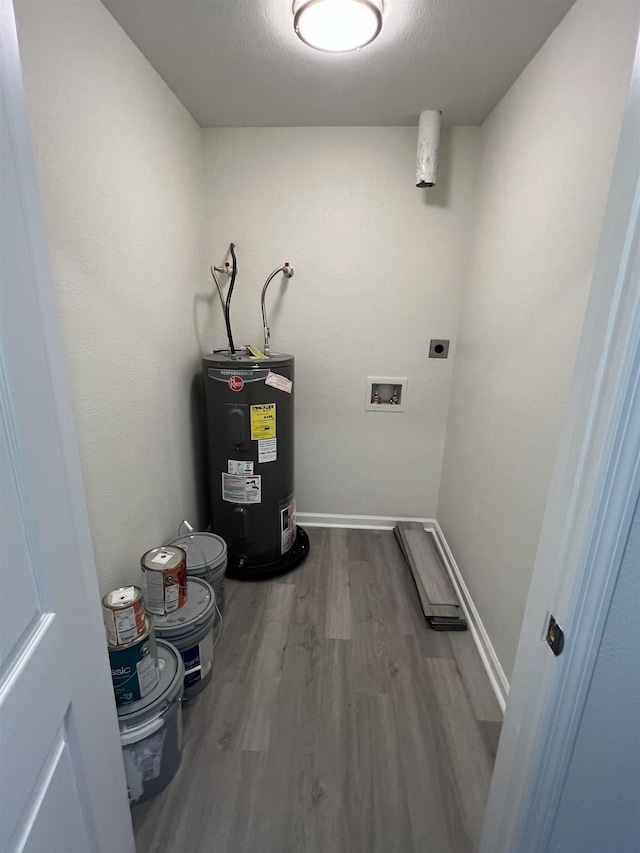 laundry room with laundry area, baseboards, wood finished floors, electric water heater, and electric dryer hookup