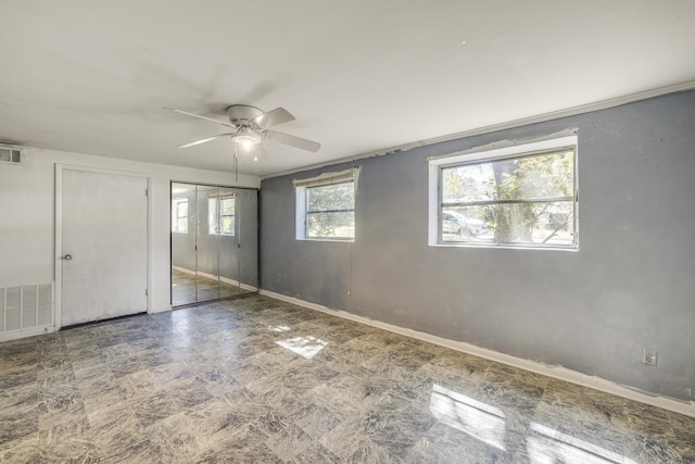 unfurnished bedroom featuring a ceiling fan, two closets, visible vents, and baseboards