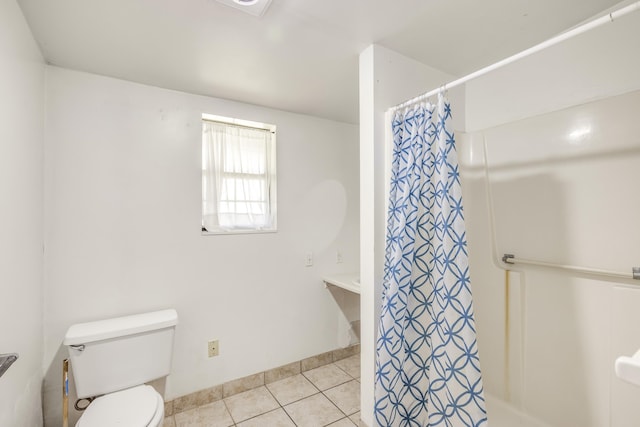 bathroom with baseboards, tile patterned flooring, toilet, and a shower with curtain