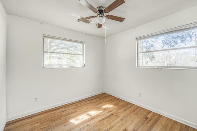 unfurnished room with light wood-style flooring, baseboards, and ceiling fan