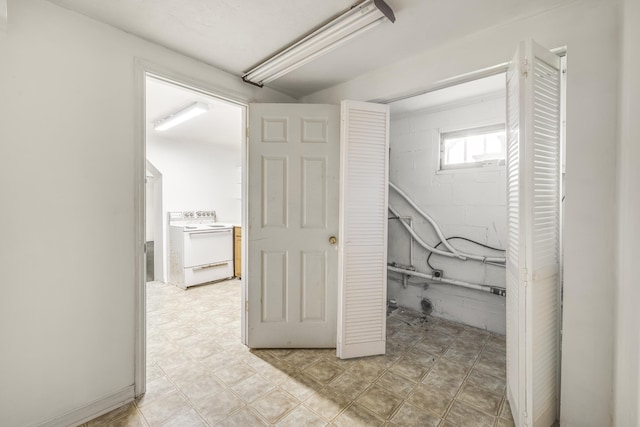 interior space featuring washer / dryer and concrete block wall