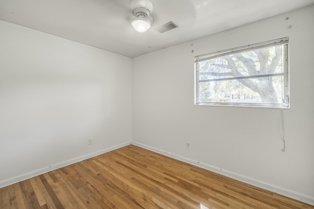 spare room with light wood-style floors, baseboards, and a ceiling fan