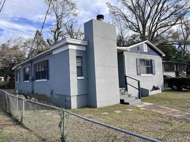 view of side of home featuring a yard