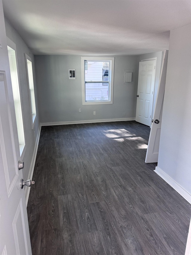 empty room featuring dark hardwood / wood-style flooring