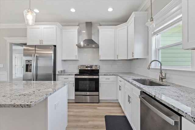 kitchen with white cabinets, wall chimney exhaust hood, sink, and appliances with stainless steel finishes