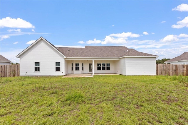 rear view of property featuring a patio area and a yard