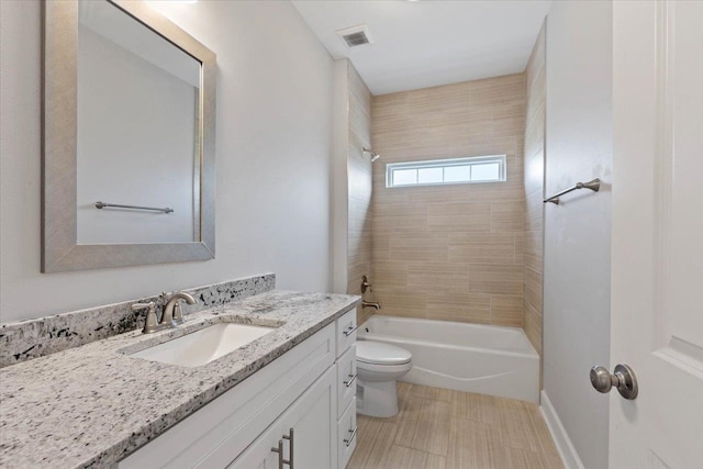 full bathroom with vanity, toilet, and tiled shower / bath