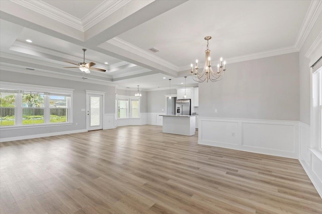 unfurnished living room featuring ornamental molding, a wealth of natural light, and light hardwood / wood-style floors