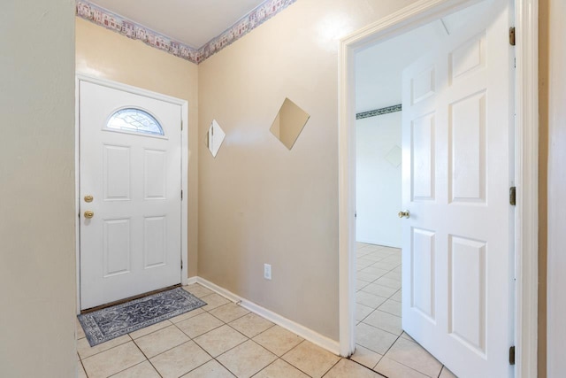 foyer entrance with light tile patterned floors