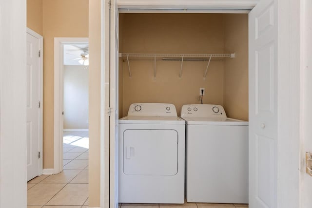 clothes washing area with washer and clothes dryer and light tile patterned flooring