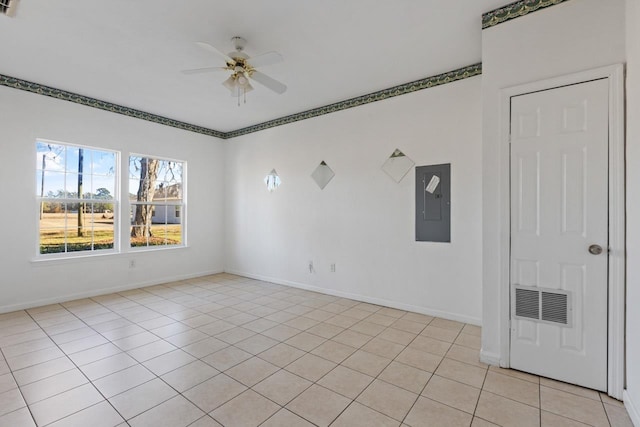 unfurnished room with ceiling fan, electric panel, and light tile patterned floors