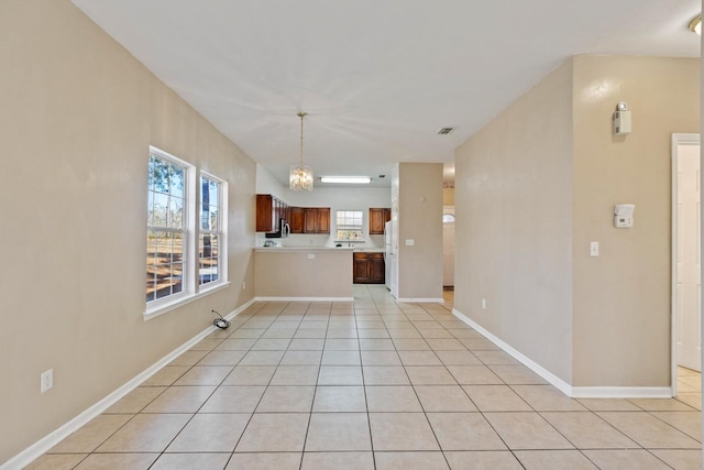 unfurnished living room featuring light tile patterned floors