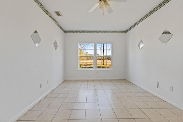 tiled spare room featuring ceiling fan