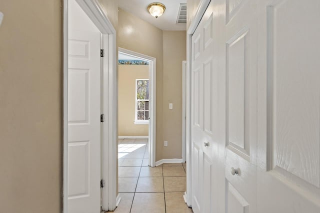 corridor with light tile patterned flooring