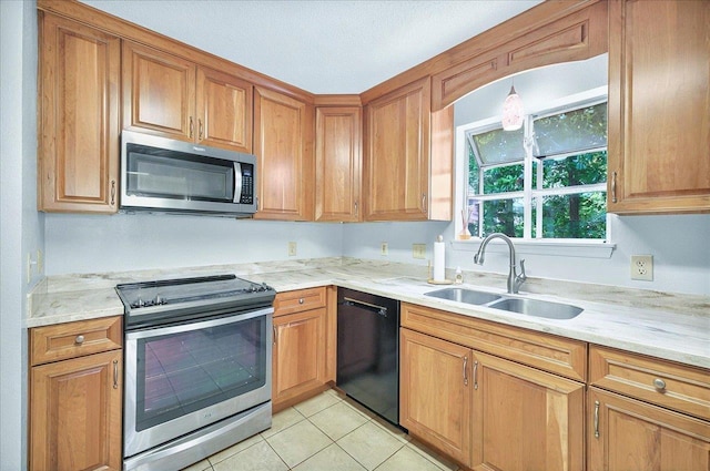 296 Timberlane Rd, Tallahassee, FL 32312 - kitchen with appliances with stainless steel finishes, a sink, light tile patterned floors, and brown cabinetry