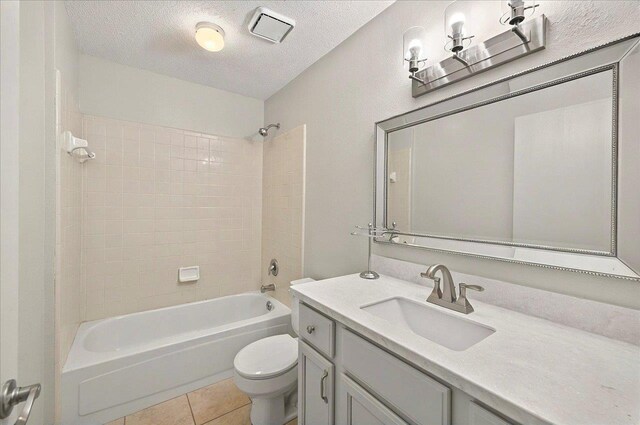 296 Timberlane Rd, Tallahassee, FL 32312 - full bath featuring toilet, vanity, shower / washtub combination, a textured ceiling, and tile patterned flooring