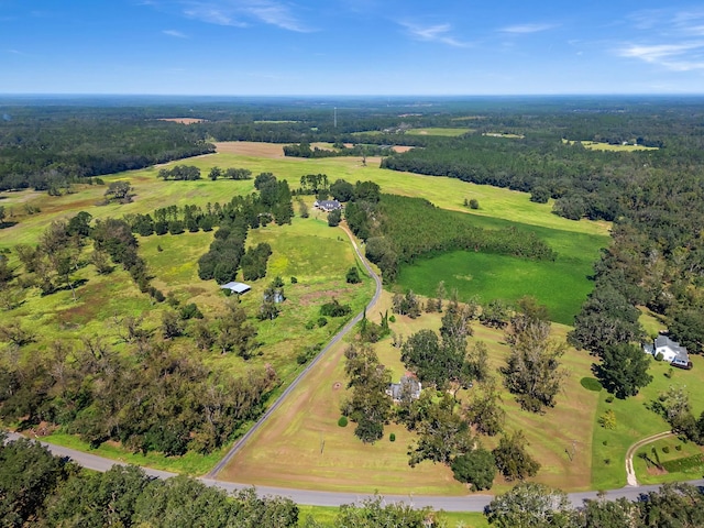 aerial view featuring a view of trees and a rural view