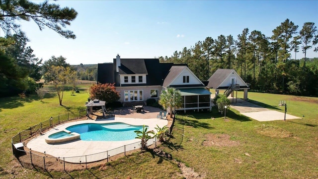 view of swimming pool featuring a pool with connected hot tub, a gazebo, a sunroom, a patio area, and fence