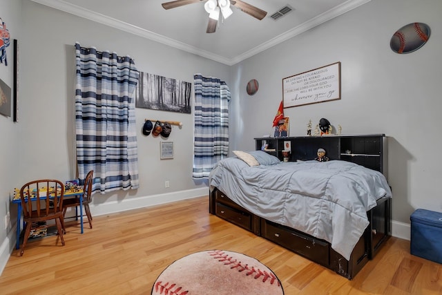 bedroom with visible vents, crown molding, light wood-style flooring, and baseboards