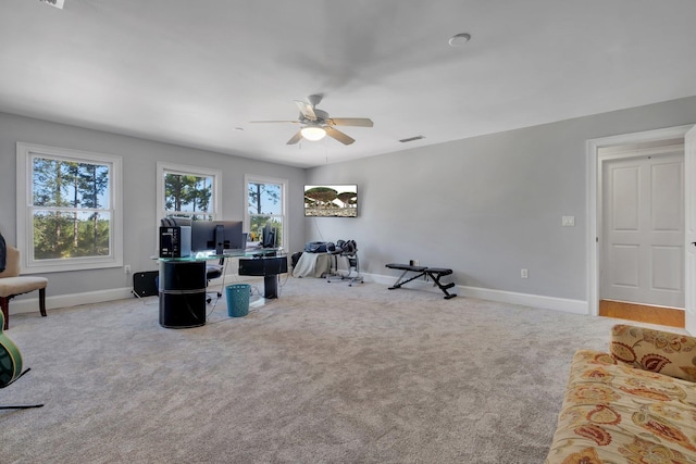 interior space with light carpet, ceiling fan, visible vents, and baseboards