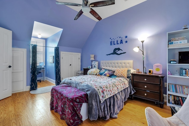 bedroom featuring a ceiling fan, light wood-type flooring, lofted ceiling, and baseboards