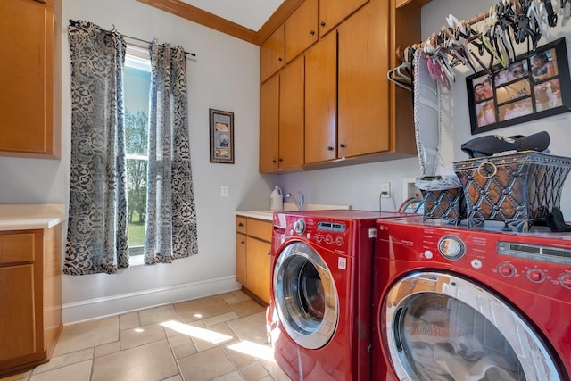 washroom featuring cabinet space, washing machine and dryer, plenty of natural light, and baseboards