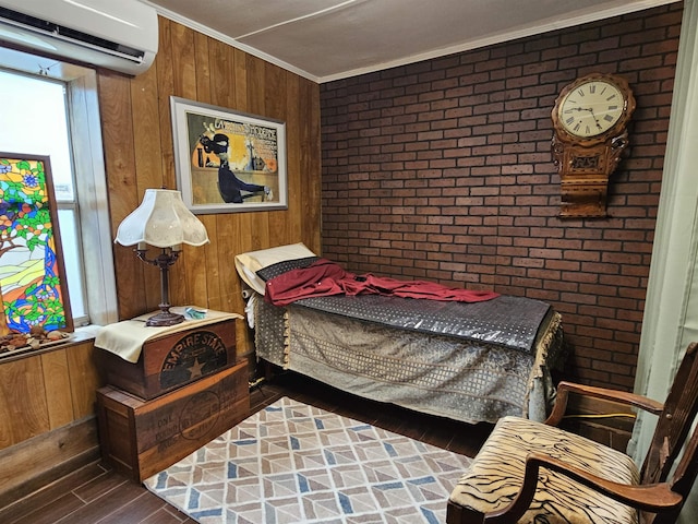 bedroom featuring brick wall, dark hardwood / wood-style floors, a wall mounted air conditioner, wood walls, and crown molding