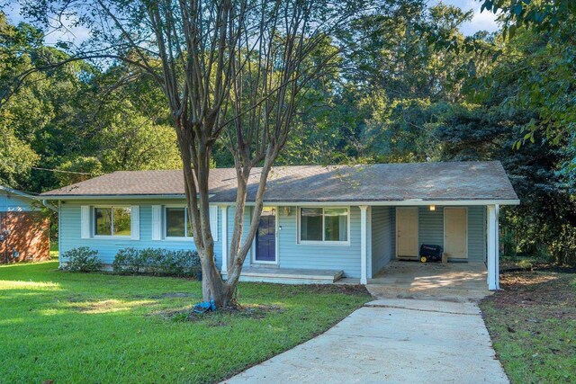 single story home featuring a front lawn and a carport