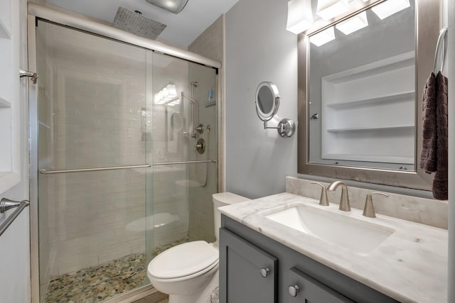 bathroom with vanity, toilet, and walk in shower