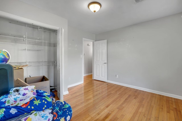 bedroom with a closet and light hardwood / wood-style flooring