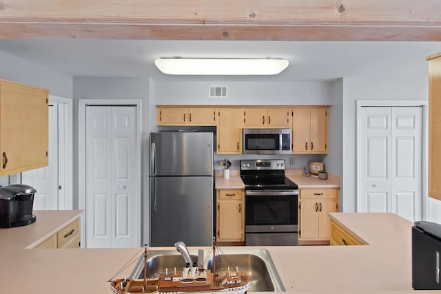 22 Lighthouse Pt, Crawfordville, FL 32327 - kitchen with stainless steel appliances, light countertops, and light brown cabinetry
