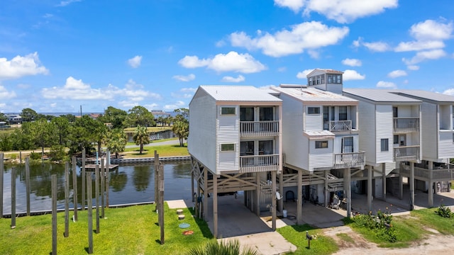 22 Lighthouse Pt, Crawfordville, FL 32327 - rear view of house with a carport, a metal roof, and a water view